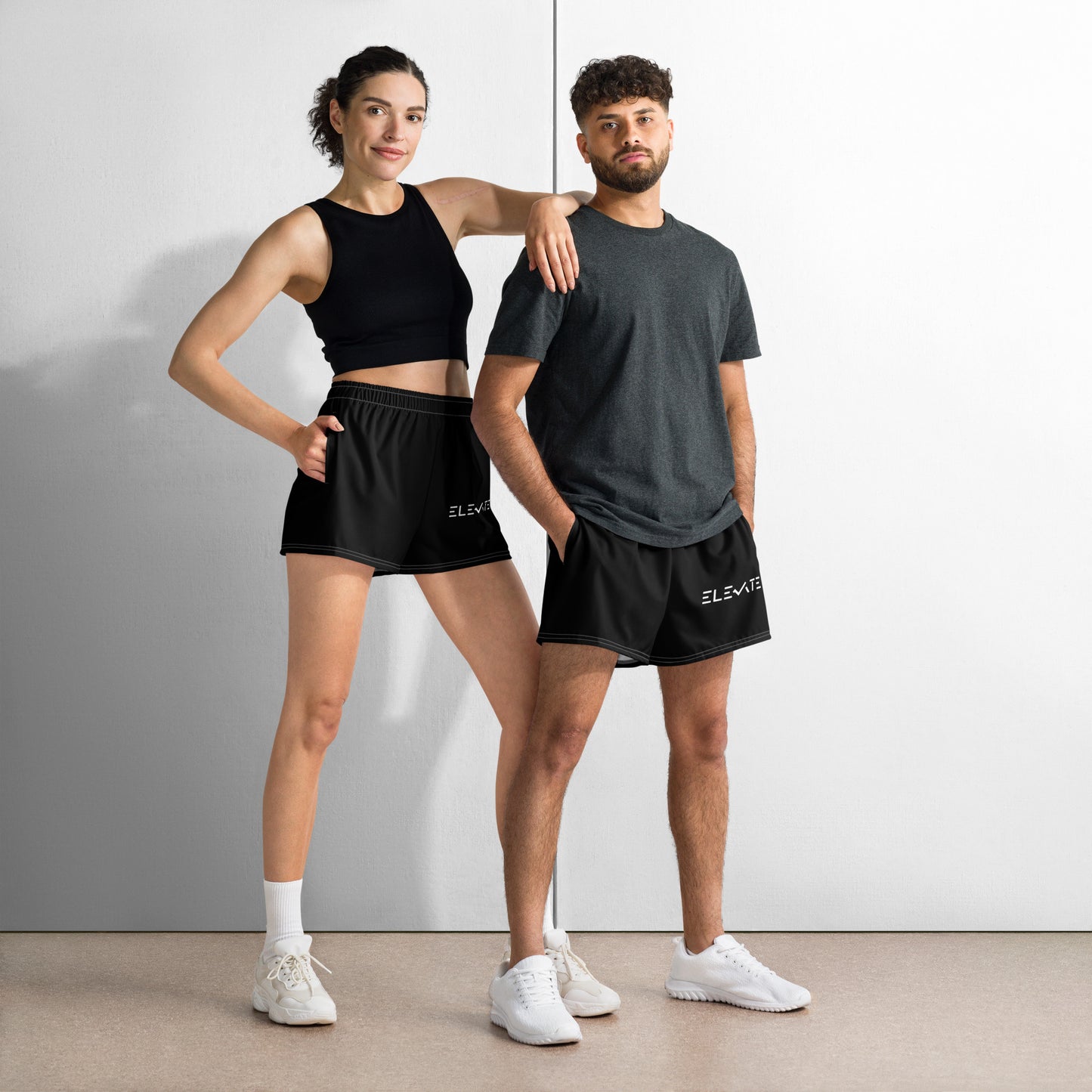unisex athletic shorts worn by male and female models, showcasing lightweight and breathable sports wear.