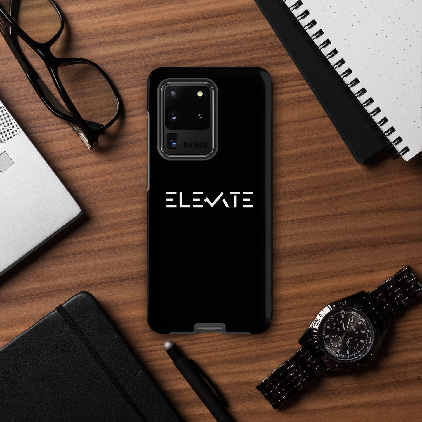 tough case for samsung shown on a wooden desk with accessories, providing sleek protection for your device.